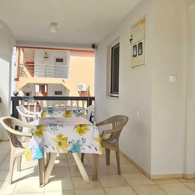 Spacious covered balcony in Ulcinj, Montenegro with beige tiles, perfect for investment&mdash;browse more with immorenta.me by Ekosphere.