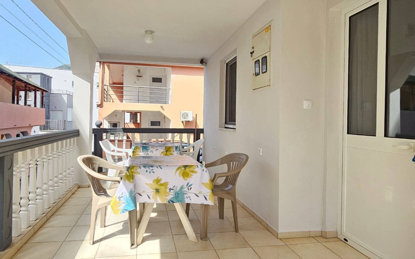 Spacious covered balcony in Ulcinj, Montenegro with beige tiles, perfect for investment&mdash;browse more with immorenta.me by Ekosphere.