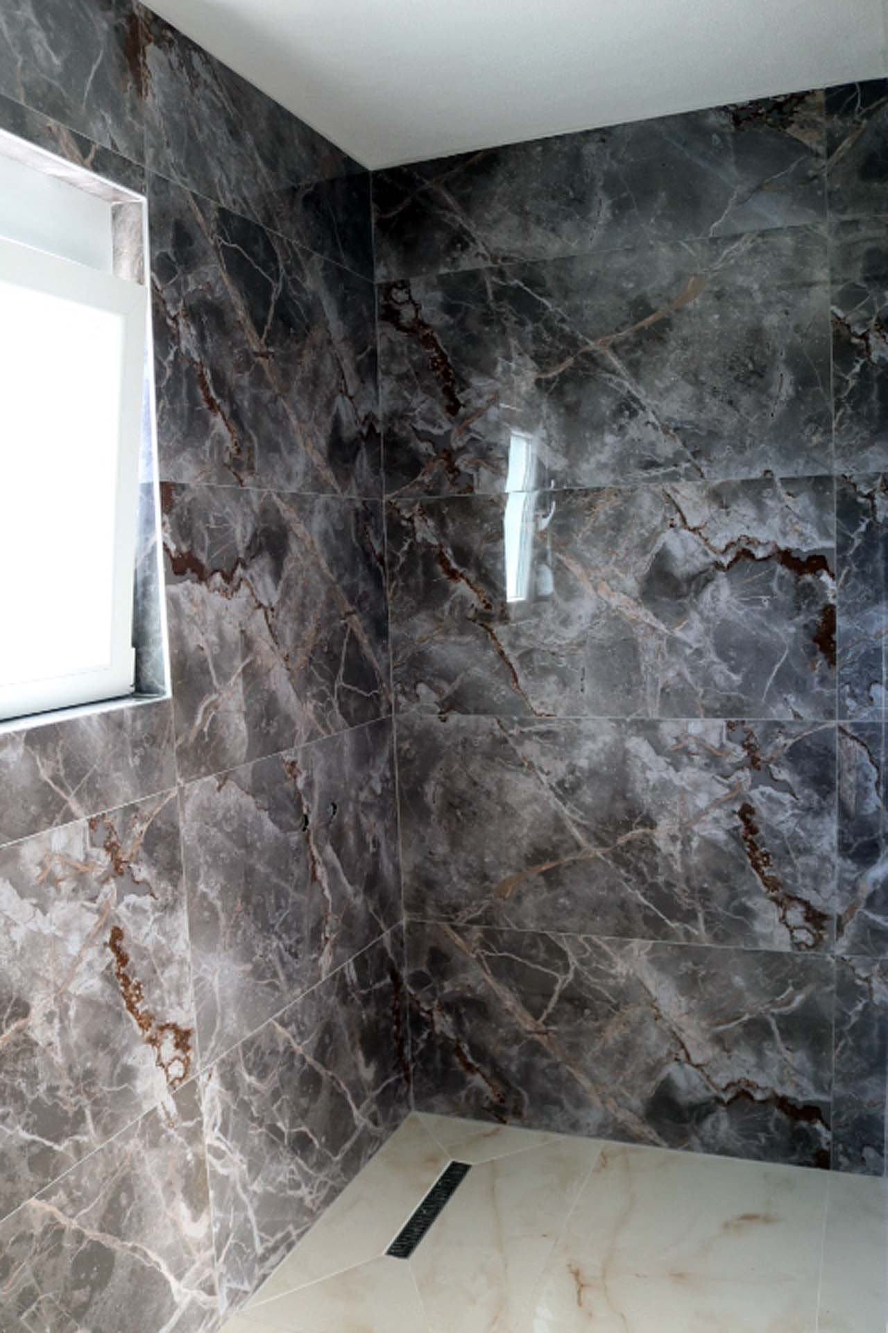 Luxurious Adana Villa shower with marble tiles, niche, frosted window&mdash;premium Ulcinj real estate on immorenta.me by ekosphere doo.