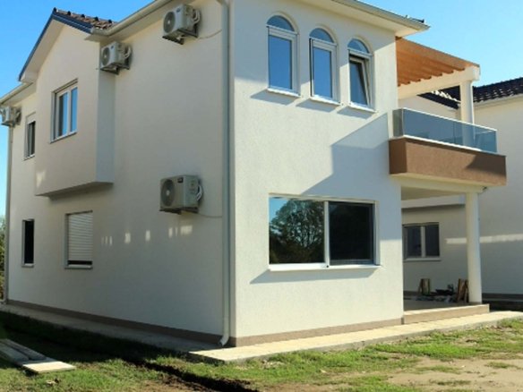Elegant modern two-story villa in Ulcinj, Montenegro with white facade, glass balcony, A/C units; exclusive at immorenta.me by ekosphere doo.