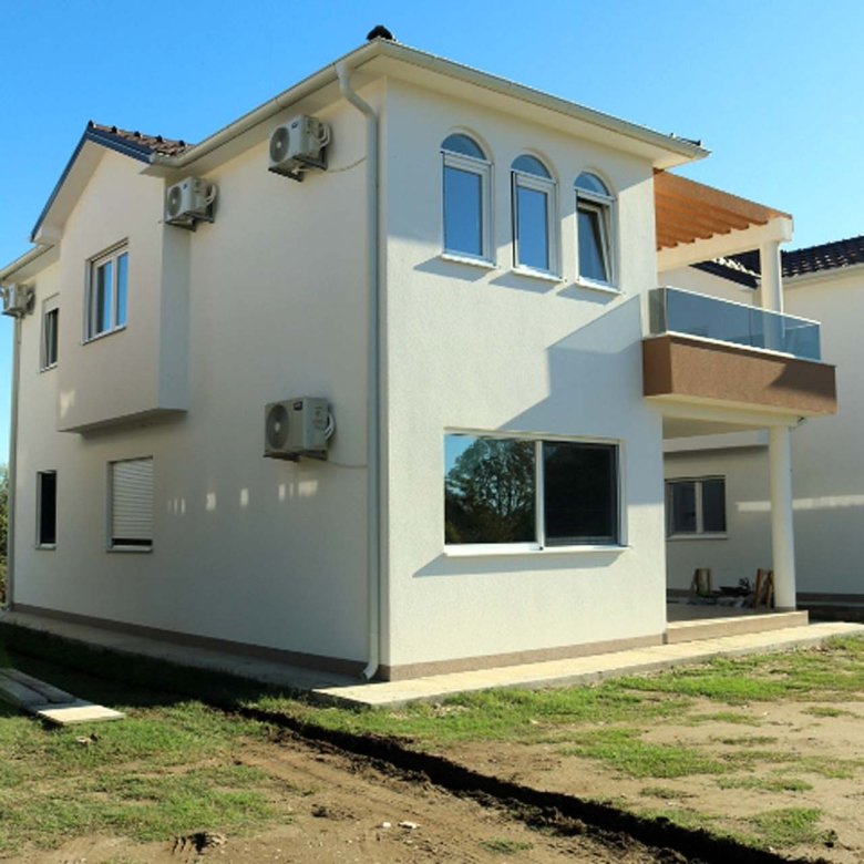 Elegant modern two-story villa in Ulcinj, Montenegro with white facade, glass balcony, A/C units; exclusive at immorenta.me by ekosphere doo.