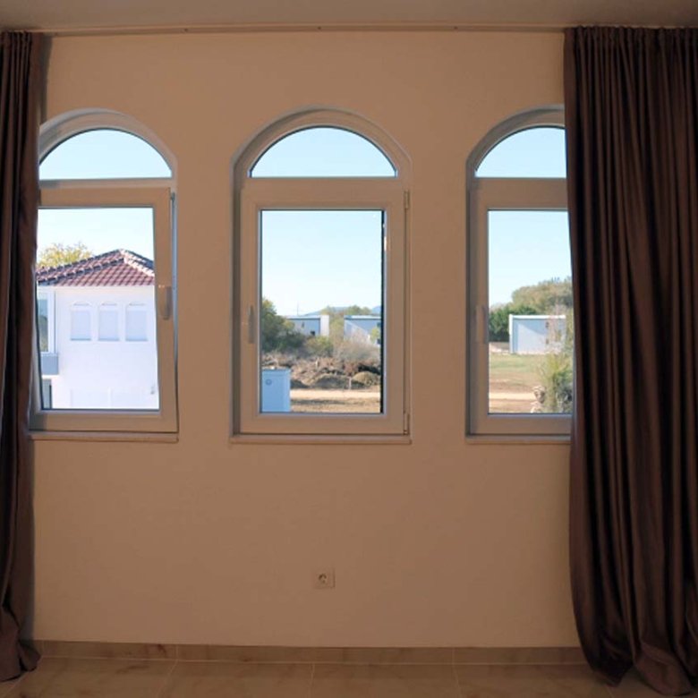 Adana Villa in Ulcinj features elegant tall windows, luxe drapes, and AC&mdash;prime real estate at immorenta.me by ekosphere doo.