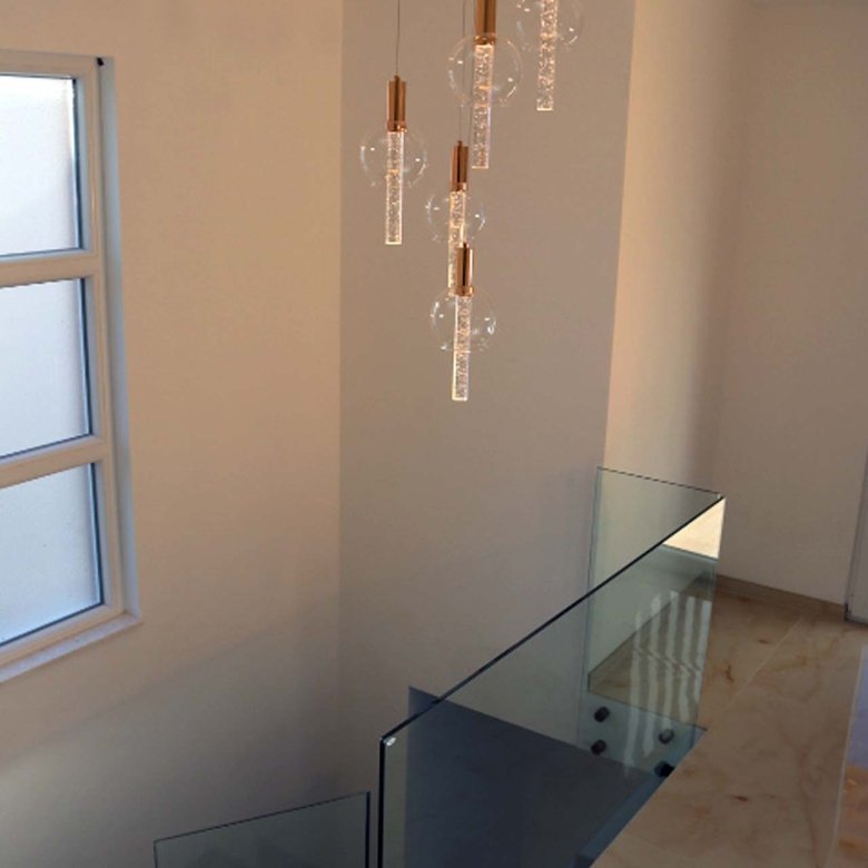 Elegant staircase with glass railings, beige floors, and natural light&mdash;luxury Ulcinj villa listed on immorenta.me by ekosphere doo.