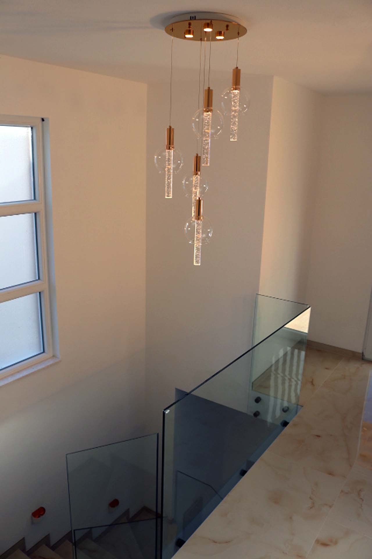 Elegant staircase with glass railings, beige floors, and natural light&mdash;luxury Ulcinj villa listed on immorenta.me by ekosphere doo.