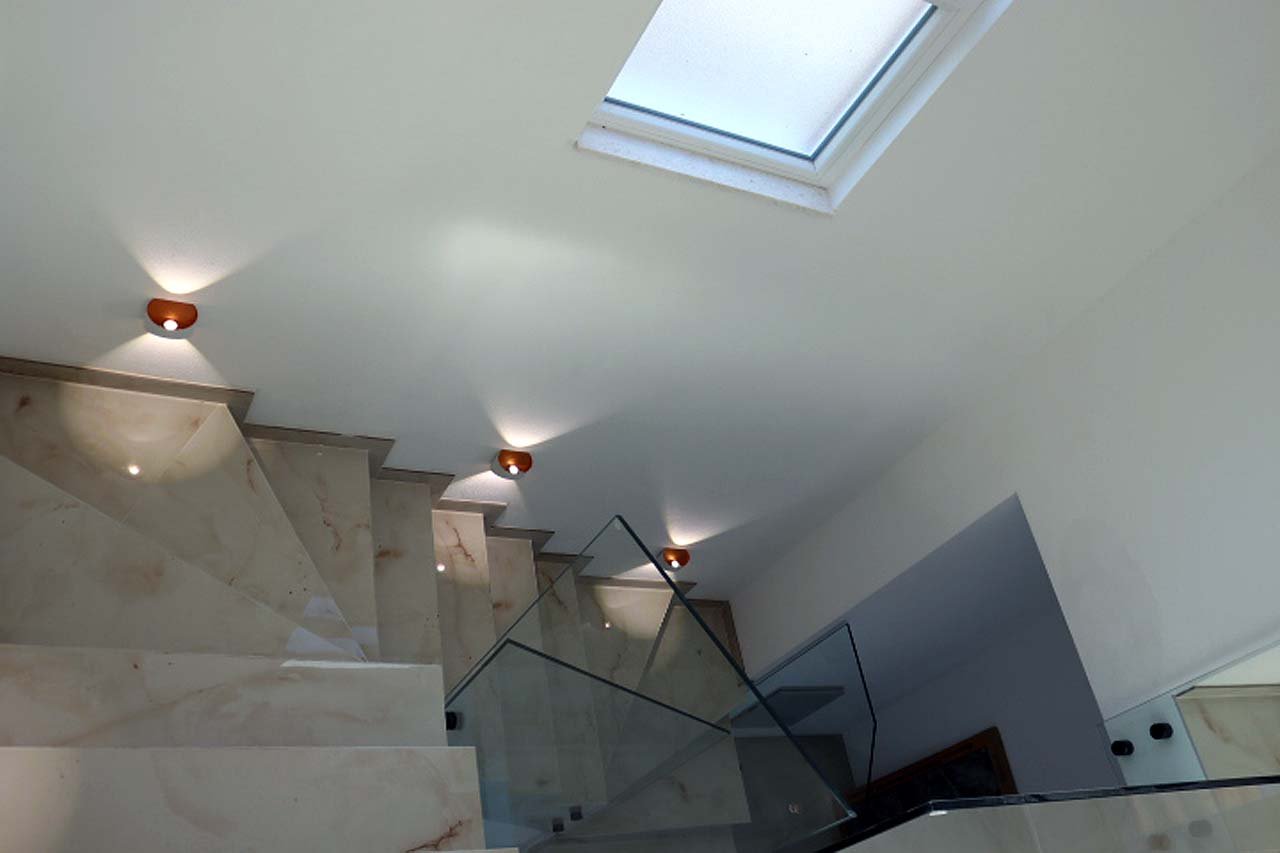 Elegant marble staircase with glass railing, skylight, and designer lighting&mdash;luxury Ulcinj villa investment via immorenta.me.