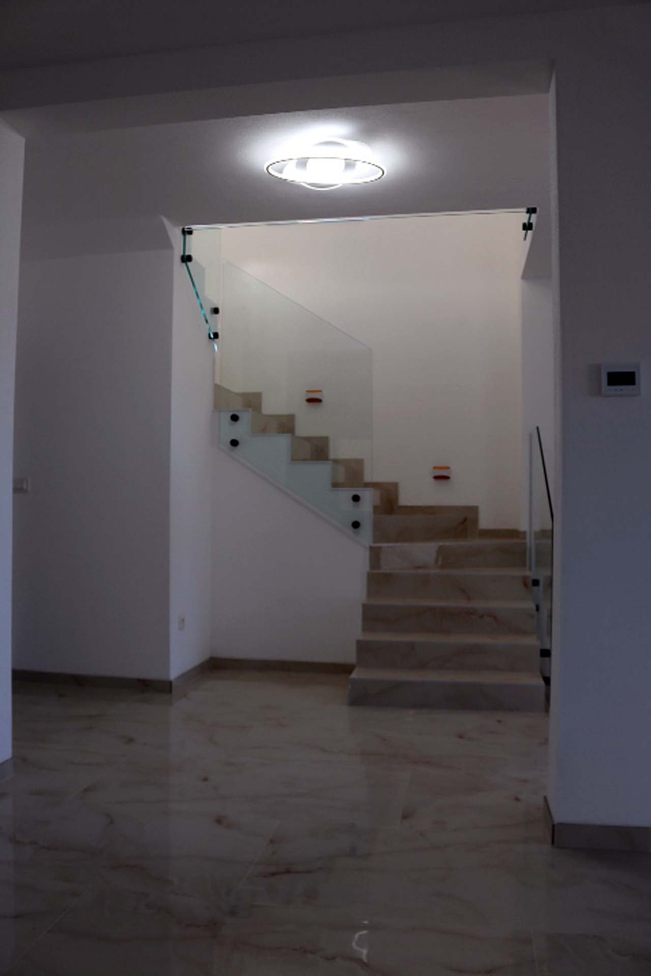 Elegant marble staircase with glass railings in Adana Villa, Ulcinj; bright, modern design&mdash;prime Montenegro investment via ekosphere doo.