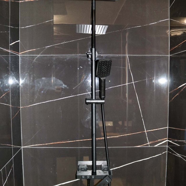 Luxurious Ulcinj bathroom featuring a modern rain shower, black fixtures, and elegant dark tiles&mdash;exclusive on immorenta.me by ekosphere doo.