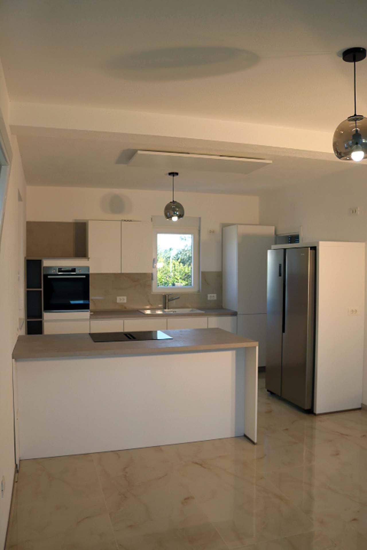 Luxurious Adana Villa kitchen in Ulcinj: white cabinets, island cooktop, marble floors&mdash;ideal real estate at immorenta.me.