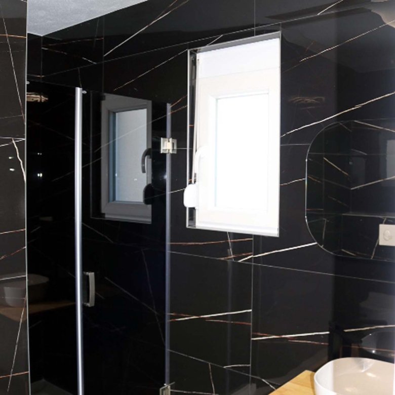 Luxury bathroom in Adana Villa, Ulcinj: elegant black-gold tiles, glass shower, designer sink; investment via immorenta.me (ekosphere doo).