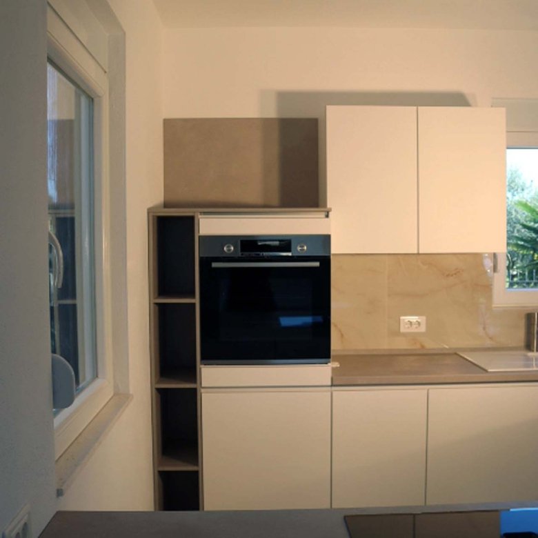 Stunning Adana Villa kitchen in Ulcinj: sleek white cabinets, premium appliances, abundant light&mdash;invest via immorenta.me!.