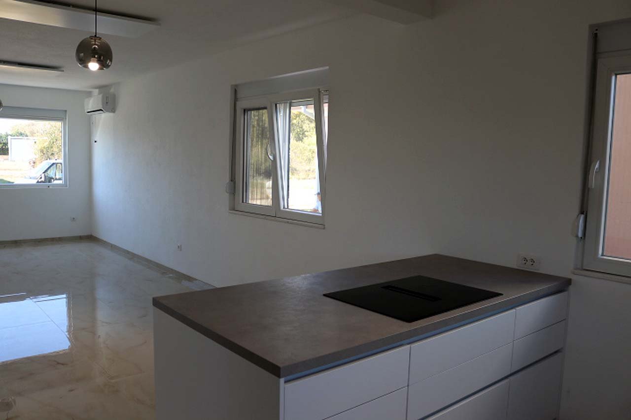 Stunning unfurnished Adana Villa in Ulcinj: bright, tiled floors, large windows, modern kitchen&mdash;prime Montenegro investment via ekosphere doo.