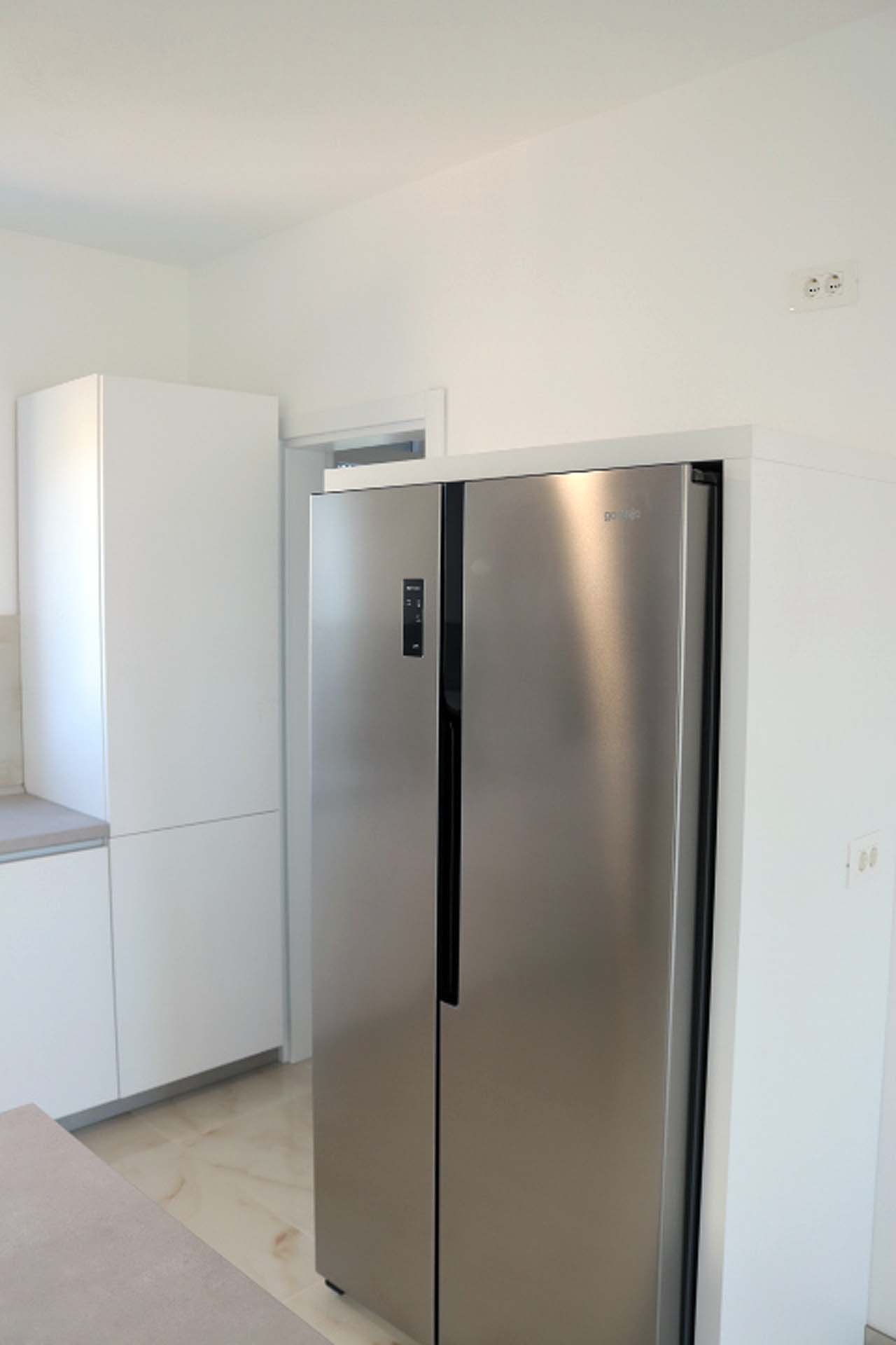 Sleek stainless steel fridge and minimalist kitchen in Adana Villa, Ulcinj&mdash;prime investment on immorenta.me by ekosphere doo.