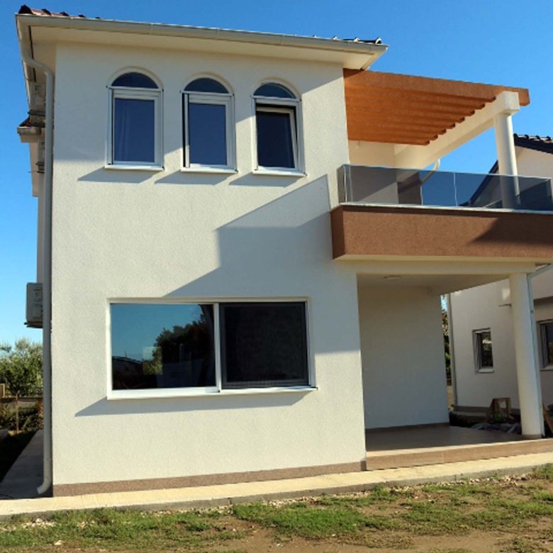 Stunning two-story Adana Villa in Ulcinj, Montenegro&mdash;white fa&ccedil;ade, arched windows, balcony, glass railings, exclusive at immorenta.me by ekosphere doo.