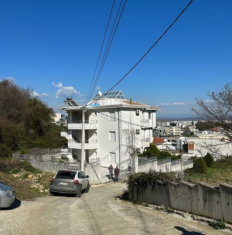 White multi-story property in Ulcinj, Montenegro on a quiet road&mdash;prime real estate investment by ekosphere doo for immorenta.me.