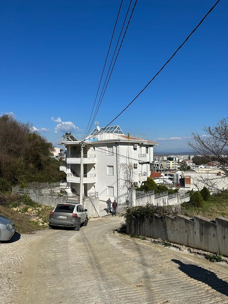White multi-story property in Ulcinj, Montenegro on a quiet road&mdash;prime real estate investment by ekosphere doo for immorenta.me.