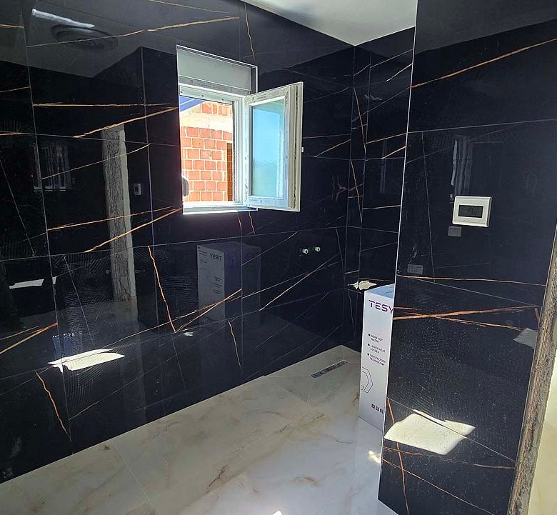 Under-construction Ulcinj property with sleek black tiled walls & sunlit space&mdash;prime investment via immorenta.me by Ekosphere.