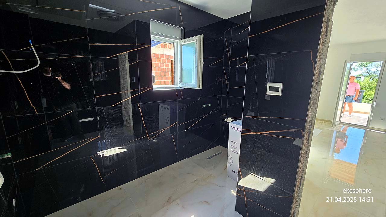 Under-construction Ulcinj property with sleek black tiled walls & sunlit space&mdash;prime investment via immorenta.me by Ekosphere.