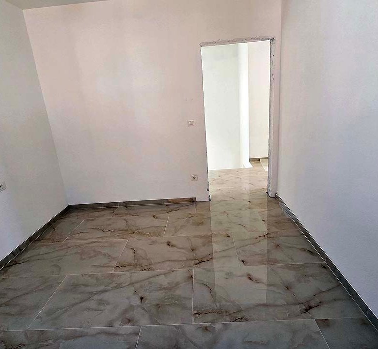 Spacious, sunlit room with marble tile floors and off-white walls&mdash;an ideal Ulcinj, Montenegro investment. Listed on immorenta.me by ekosphere doo.