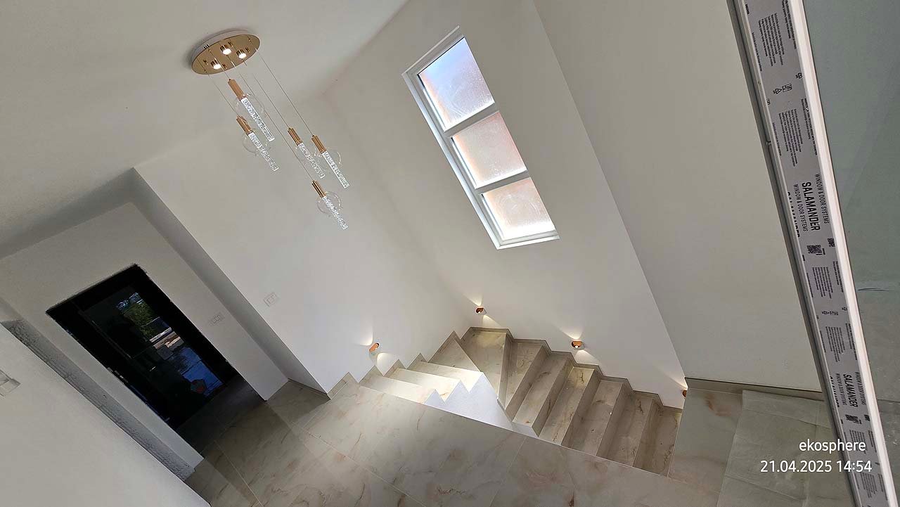 Elegant staircase with beige steps, chic lights, and tall window&mdash;ideal Ulcinj investment, listed by immorenta.me (ekosphere doo).
