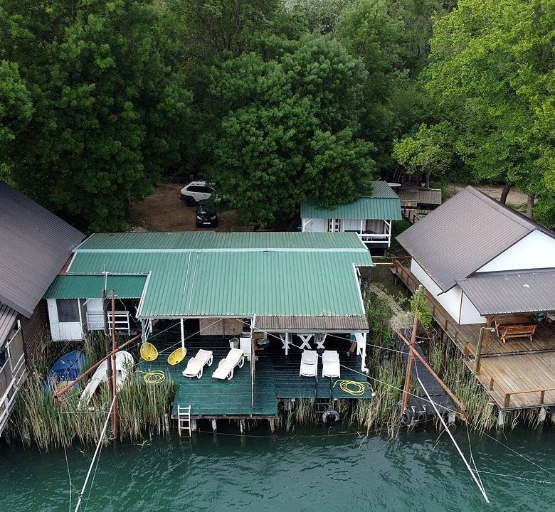 Stunning Ulcinj riverfront cabins with private decks, lush greenery; exclusive investment via immorenta.me by Ekosphere Doo.