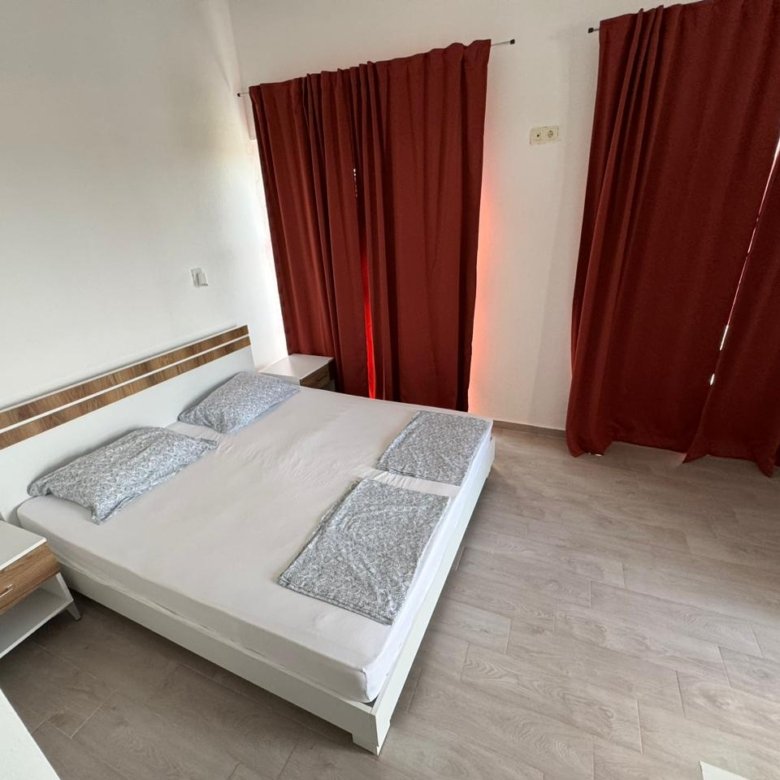 Modern Ulcinj bedroom with double bed, white walls, wood floors&mdash;ideal eco-property investment via immorenta.me by ekosphere doo.