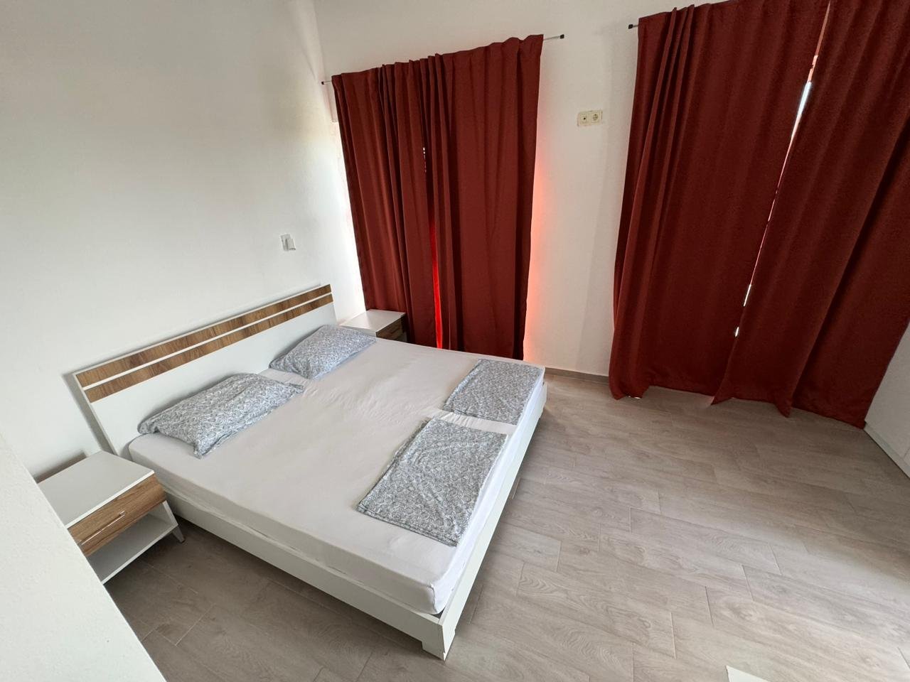 Modern Ulcinj bedroom with double bed, white walls, wood floors&acirc;ideal eco-property investment via immorenta.me by ekosphere doo.