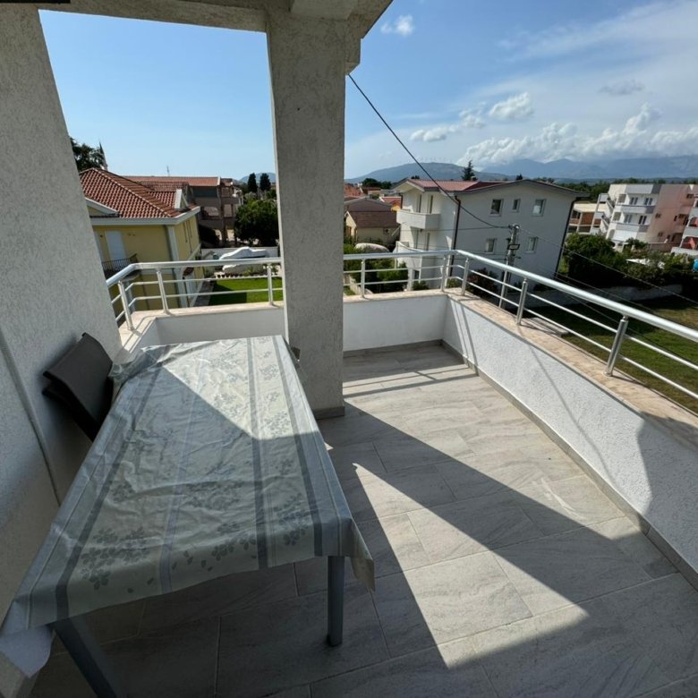 Bright balcony with table and chairs, boasting scenic Ulcinj views&mdash;premium investment on immorenta.me by ekosphere doo.