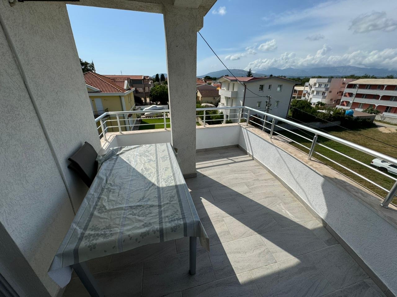 Bright balcony with table and chairs, boasting scenic Ulcinj views&acirc;premium investment on immorenta.me by ekosphere doo.