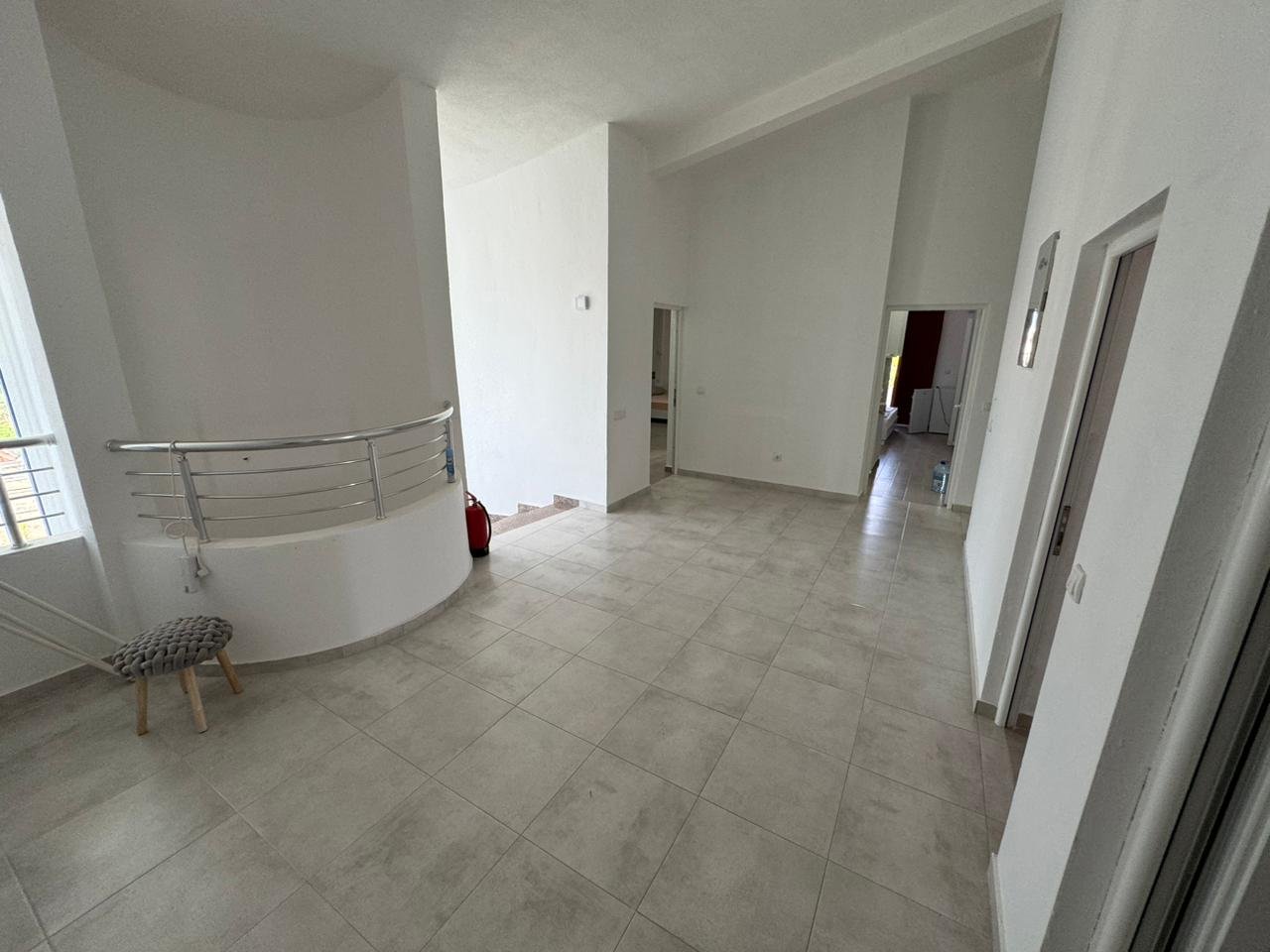 Bright, spacious room in Ulcinj with modern tiled floors, white walls, and staircase&acirc;investment potential via immorenta.me by ekosphere doo.