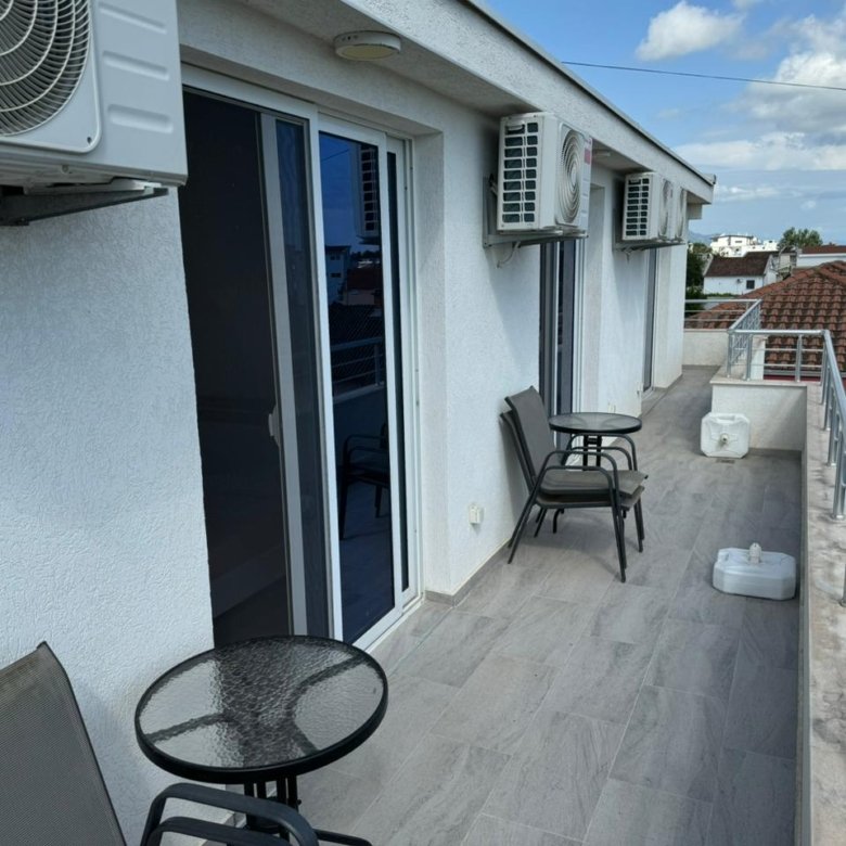 Modern Ulcinj balcony with sleek tiles, AC units, glass doors, city views&mdash;prime real estate by immorenta.me, ekosphere doo.