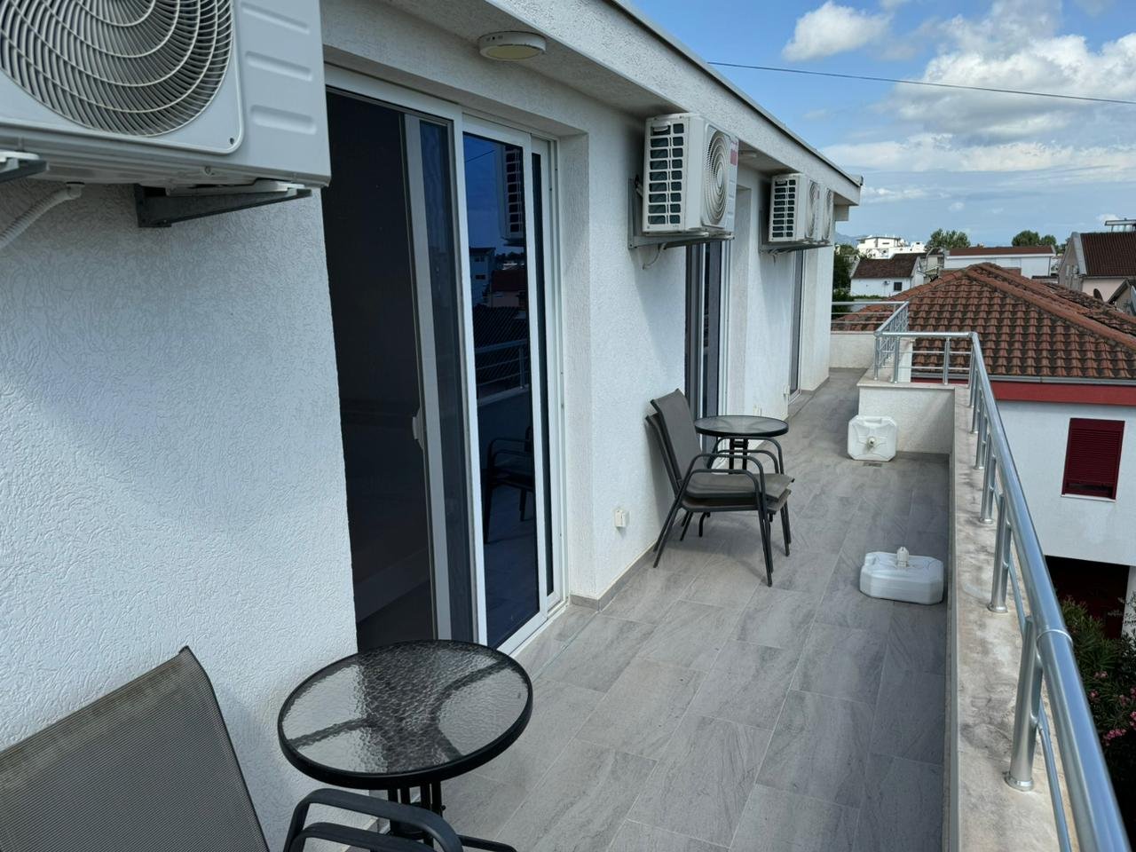 Modern Ulcinj balcony with sleek tiles, AC units, glass doors, city views&acirc;prime real estate by immorenta.me, ekosphere doo.