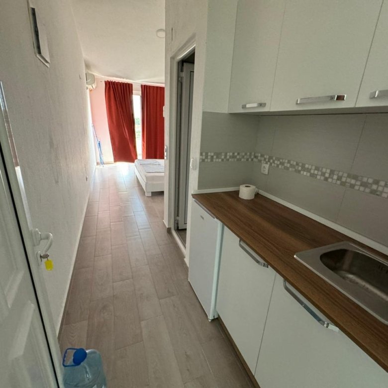 Modern Ulcinj apartment for sale: sleek kitchenette, cozy layout, bed by balcony. Top property on immorenta.me by Ekosphere DOO.