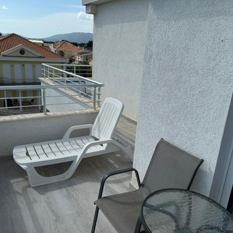 Luxury balcony in Ulcinj with stylish seating, stunning red-tile roof views&mdash;prime Montenegro property market, exclusively at immorenta.me by ekosphere doo.