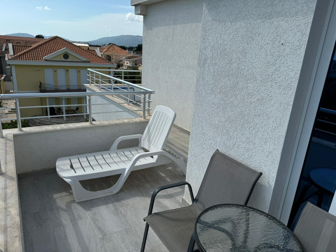 Luxury balcony in Ulcinj with stylish seating, stunning red-tile roof views&acirc;prime Montenegro property market, exclusively at immorenta.me by ekosphere doo.