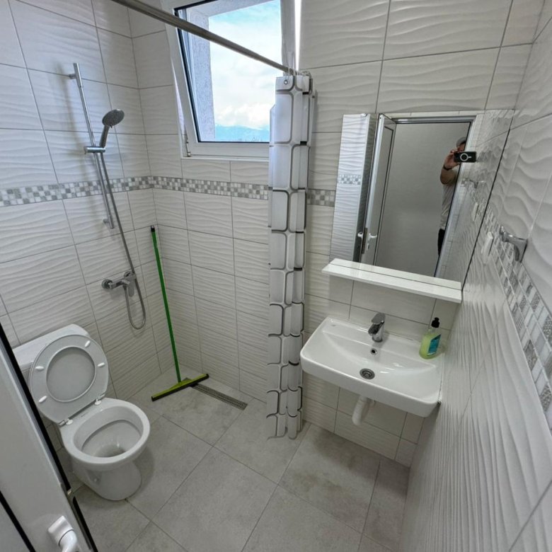 Modern tiled bathroom in Ulcinj property: toilet, sink, shower; bright space&mdash;ideal Montenegro investment. Via immorenta.me (ekosphere doo).