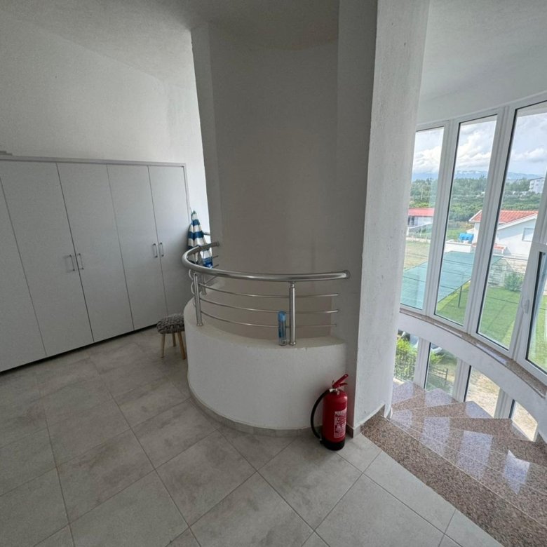 Spacious, light-filled Ulcinj room with white walls, modern wardrobe, and stylish staircase&mdash;premium Ekosphere DOO design at immorenta.me.