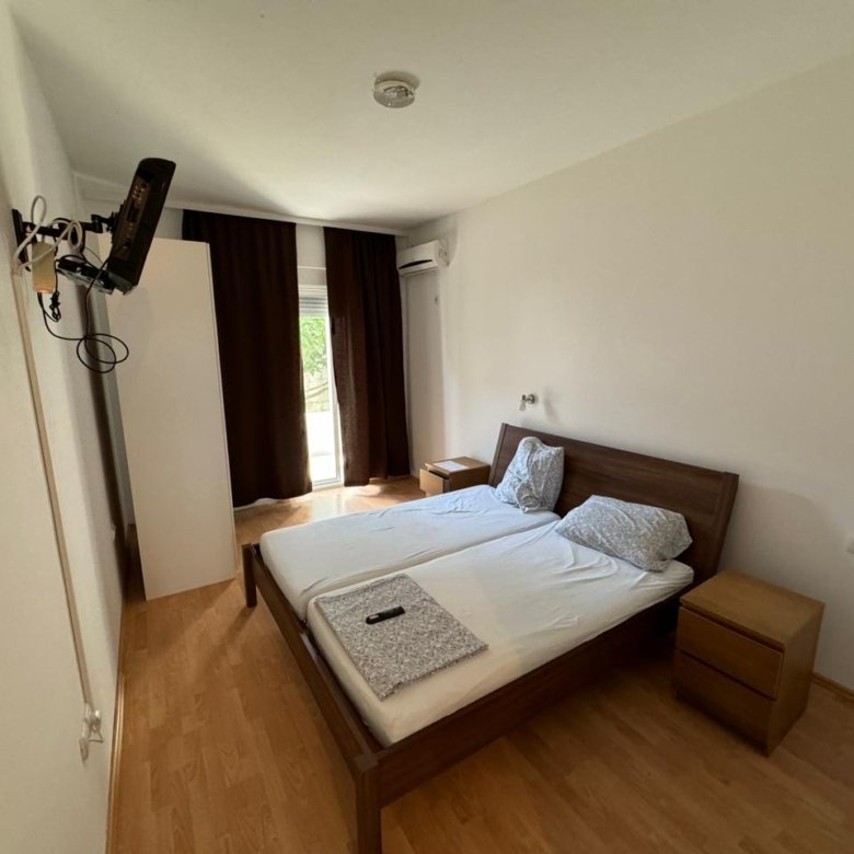 Modern bedroom for sale in Ulcinj, Montenegro: double bed, wood floors, sleek nightstands&mdash;see more on immorenta.me by Ekosphere doo.