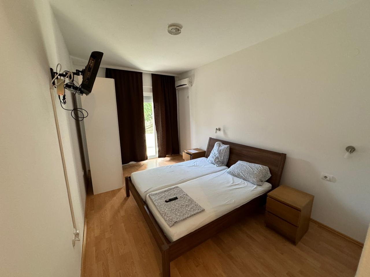 Modern bedroom for sale in Ulcinj, Montenegro: double bed, wood floors, sleek nightstands&acirc;see more on immorenta.me by Ekosphere doo.