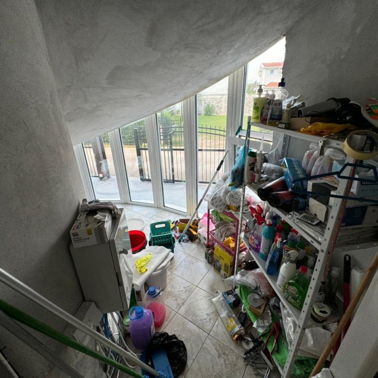 Modern storage room with tiled floors, ample shelving, large windows, and outdoor views&mdash;prime Ulcinj real estate by ekosphere doo.