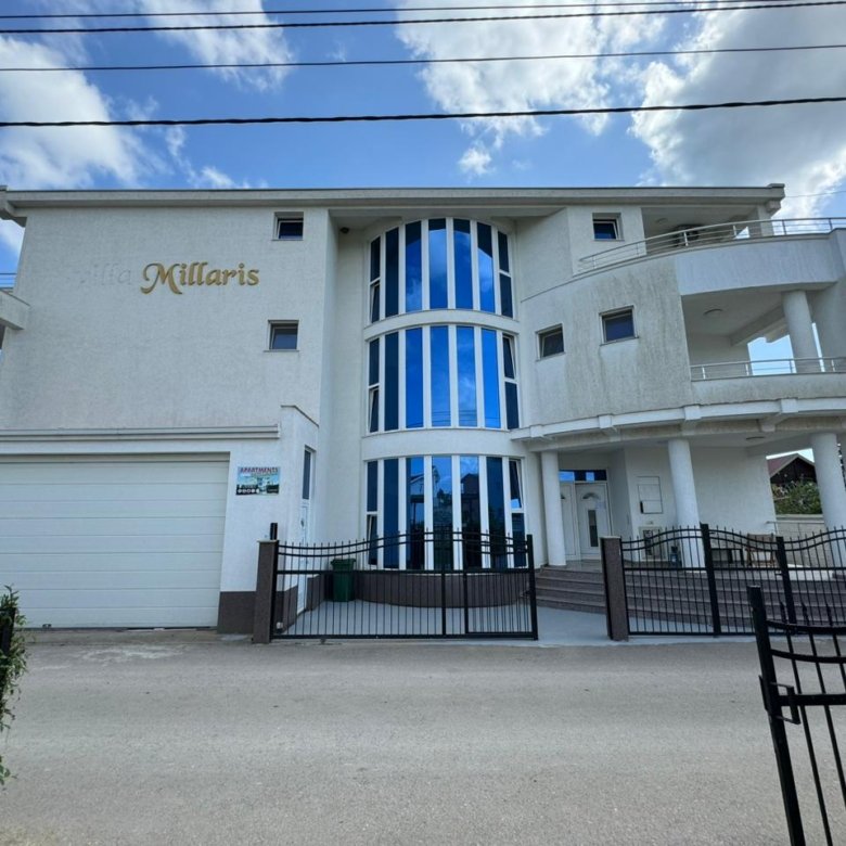 Villa Millaris: Modern 3-story luxury home in Ulcinj, Montenegro with blue-tinted windows, balconies, garage&mdash;exclusive at immorenta.me by ekosphere doo.