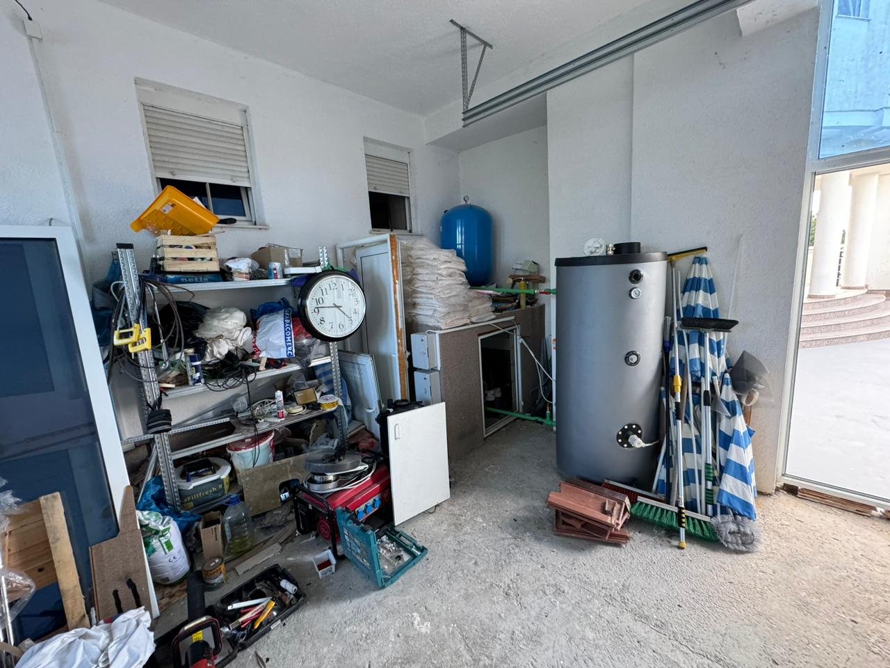 Spacious Ulcinj garage with shelving, storage, and building materials&acirc;an ideal property investment by Ekosphere on immorenta.me.