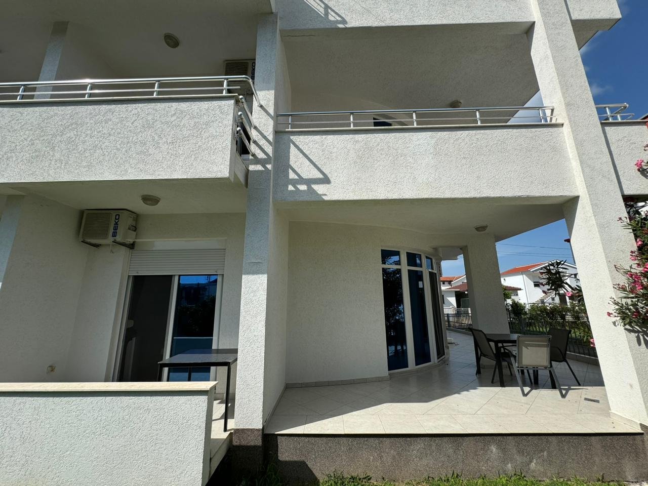 Modern white building in Ulcinj, Montenegro with balconies and patio, premium Ekosphere design. Exclusive at immorenta.me.