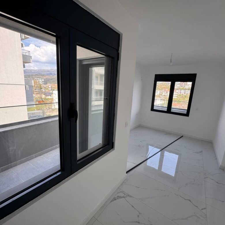 Spacious, sunlit room with white walls, marble floors, balcony views&mdash;prime Ulcinj real estate from immorenta.me by Ekosphere.