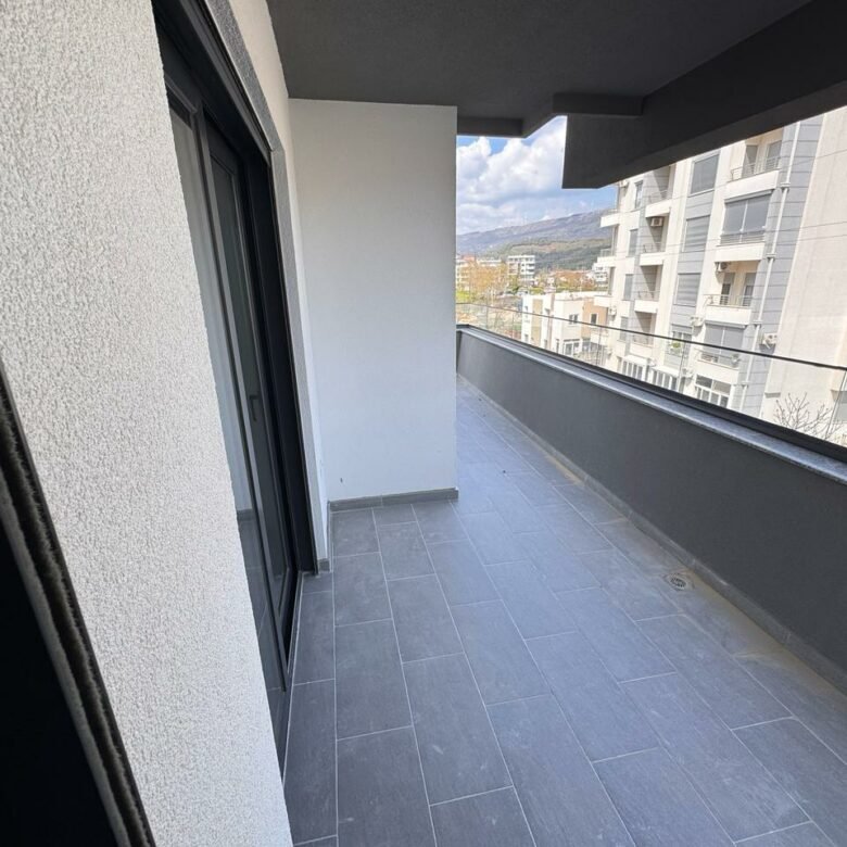 Stylish Ulcinj balcony with gray tiles, glass door, private wall; invest in Montenegro real estate via immorenta.me by ekosphere doo.