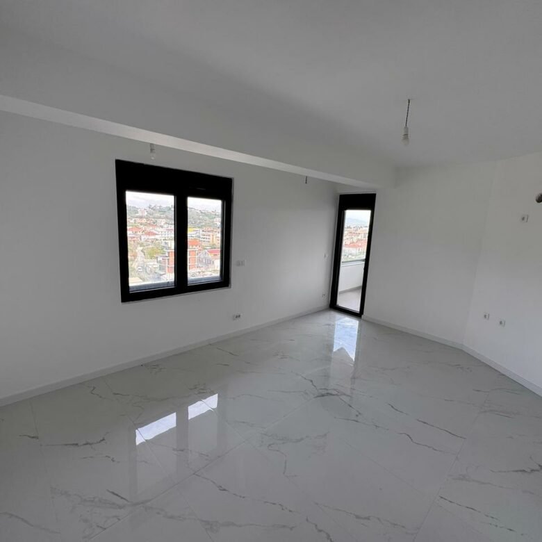 Modern Ulcinj property: bright room, marble tiles, stylish black windows. Prime investment by ekosphere doo at immorenta.me.