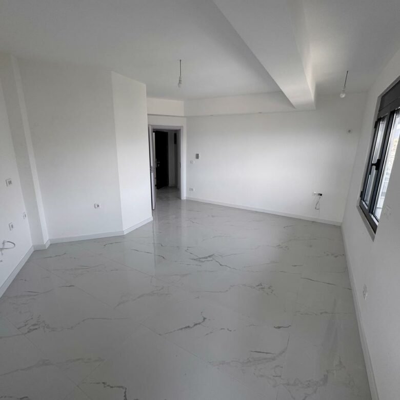 Bright, spacious room with white walls and marble tiles&mdash;prime Ulcinj real estate by ekosphere doo. Ideal property investment.