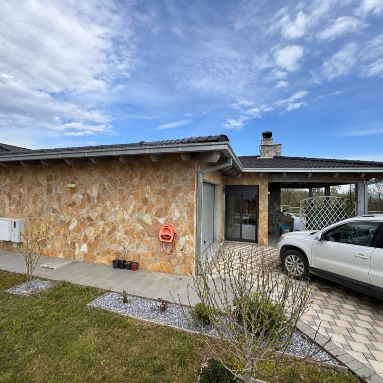 Charming Ulcinj home for sale: stone exterior, dark tile roof, carport, landscaped yard. Top investment at immorenta.me by ekosphere doo.