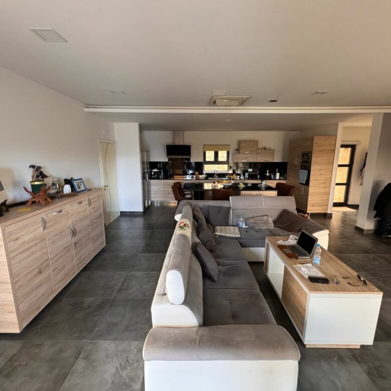 Modern open-concept living and kitchen, stylish furnishings, large tile floor. Prime Ulcinj eco-property by Ekosphere on immorenta.me.