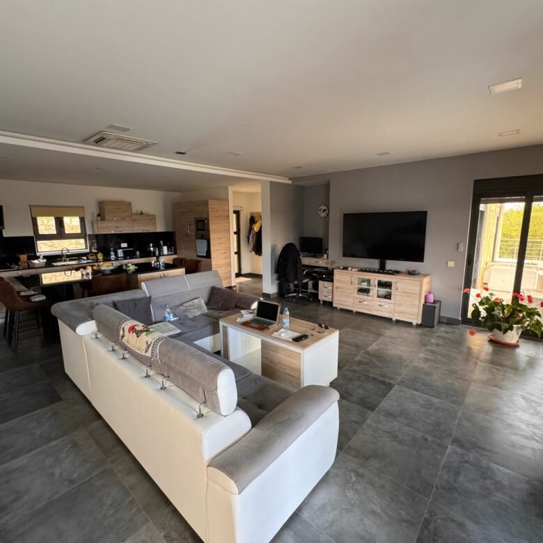 Stunning Ulcinj modern open-plan living with gray tiled floors, elegant sofa, top finishes&mdash;ideal Montenegro investment by ekosphere doo.