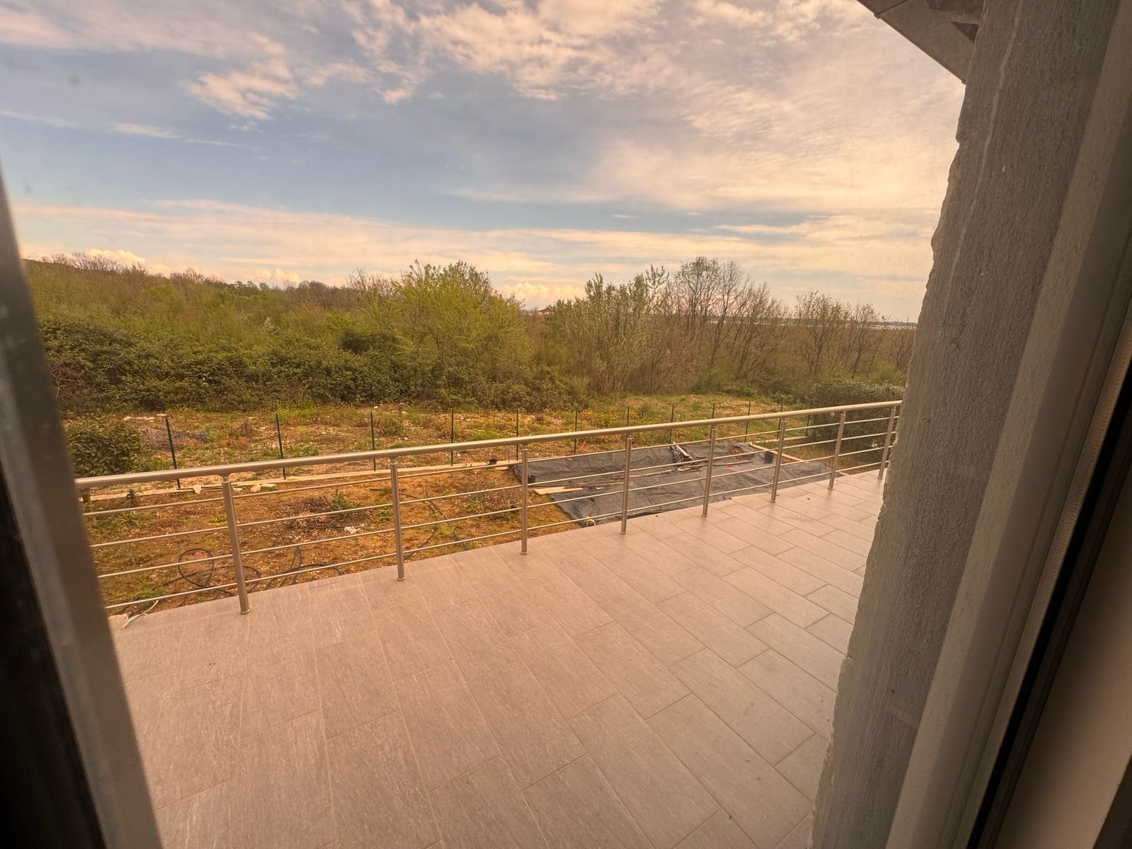 Modern tiled balcony with metal railing, lush greenery views&mdash;exclusive Ulcinj property by immorenta.me, Ekosphere doo project.